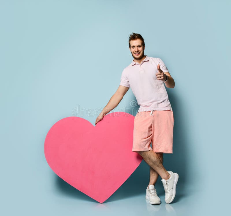 Young Handsome Man In White Polo Shirt Hold Pink Heart Shape Toy Present Gift Happy Valentines Day Concept Stock Photo Image Of February Husband 170469378