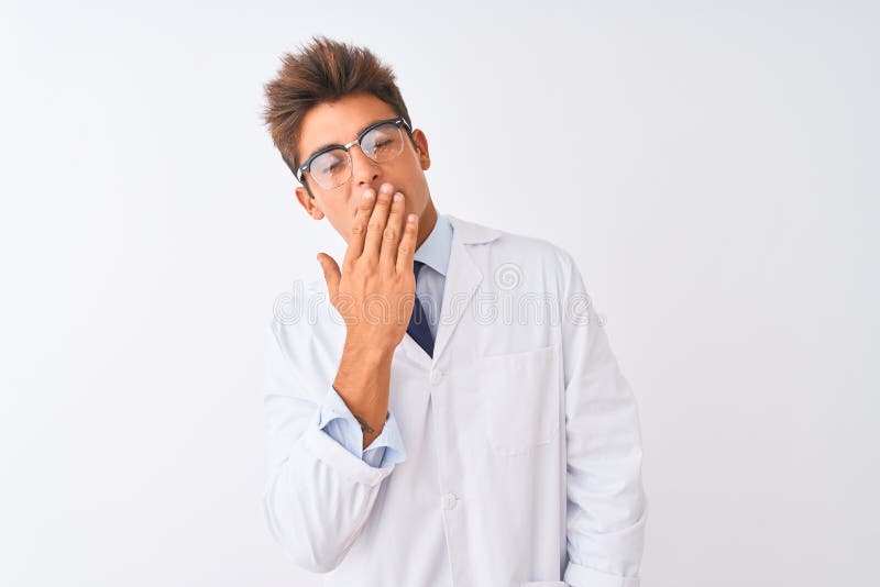Young handsome sciencist man wearing glasses and coat over isolated white background bored yawning tired covering mouth with hand
