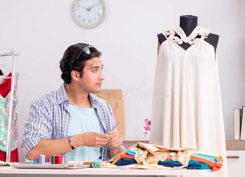 Young handsome tailor working in his workshop royalty free stock photos