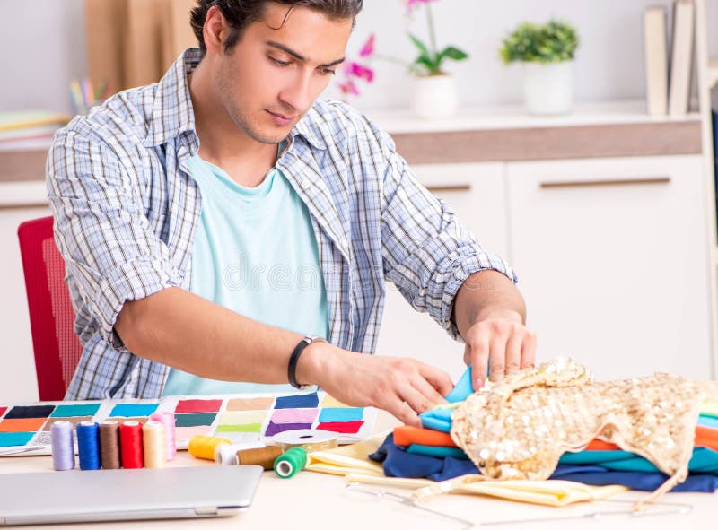 Young handsome tailor working in his workshop royalty free stock photography