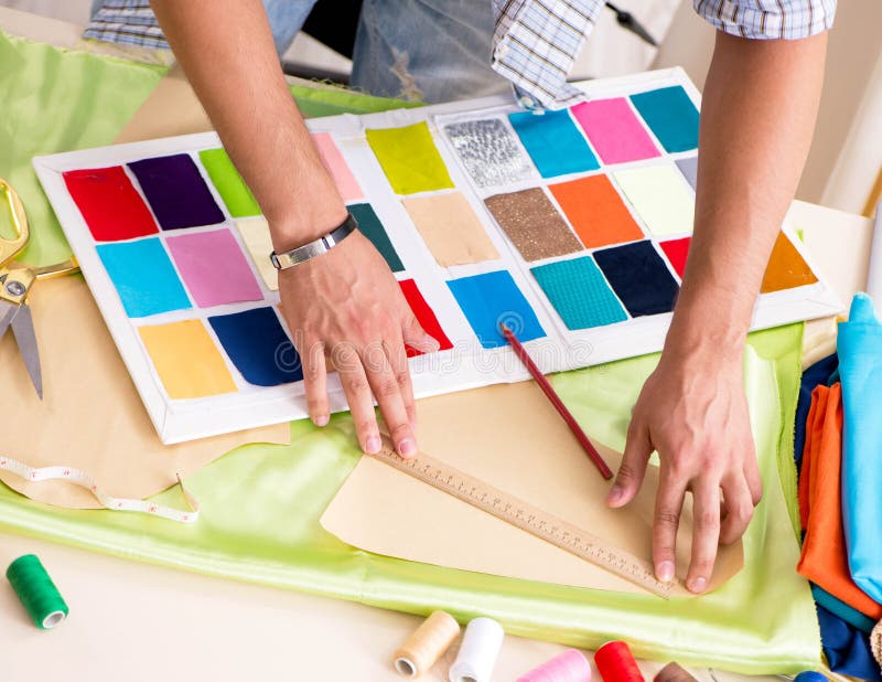 Young handsome tailor working in his workshop royalty free stock image