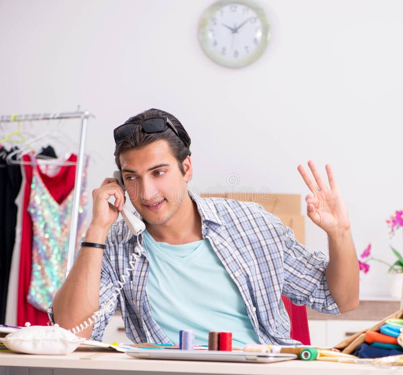 Young handsome tailor working in his workshop royalty free stock photography