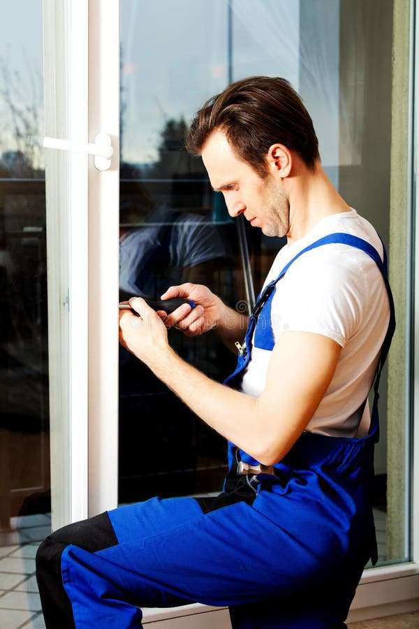 Young Handyman Repair Window with Screwdriver Stock Photo Image of