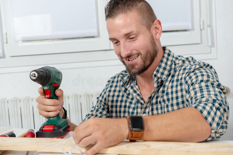 Young Handyman Using Electric Drill, DIY at Home Stock Photo Image of