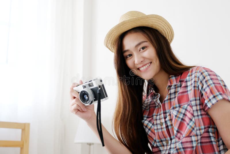 Young happy asian woman tourist holding camera, Asian traveler girl smiling while holding vintage camera on vacation royalty free stock photo Young happy asian woman tourist holding camera, Asian traveler girl smiling while holding vintage camera on vacation royalty free stock photo