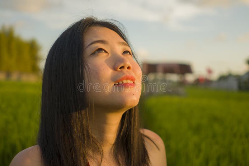 Young happy and beautiful Asian woman enjoying nature at rice field. sweet Chinese girl exploring countryside during holiday. Young happy and beautiful Asian royalty free stock photography Young happy and beautiful Asian woman enjoying nature at rice field. sweet Chinese girl exploring countryside during holiday. Young happy and beautiful Asian royalty free stock photography