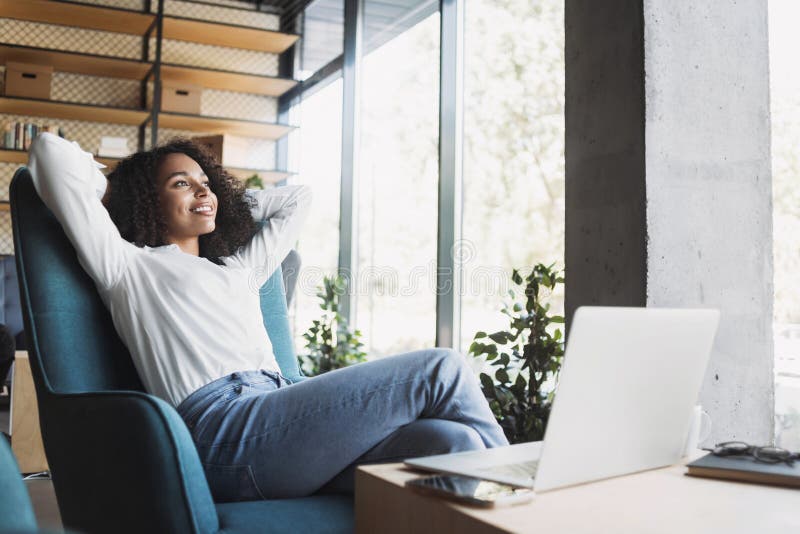 Young happy businesswoman relaxing at office lobby, Smiling woman working on laptop computer in modern office, successful business