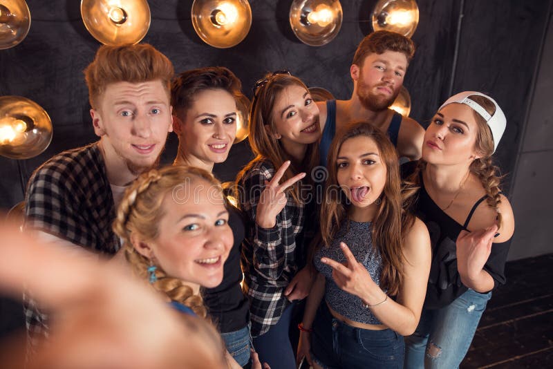 Young happy cheerful students making selfie in campus stock photo Young happy cheerful students making selfie in campus stock photo