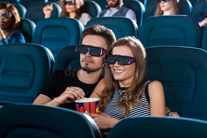Good times together. Portrait of a young loving couple hugging on a date at the 3D movie theatre. Good times together. Portrait of a young loving couple hugging on a date at the 3D movie theatre