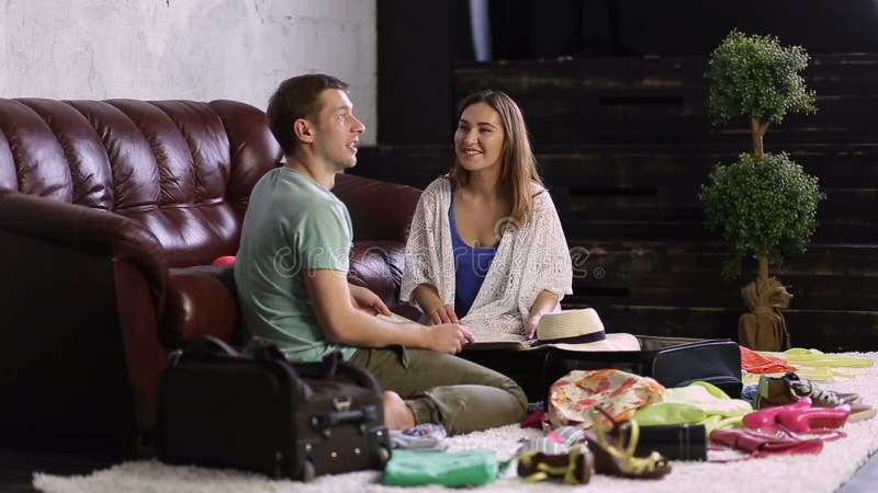 Young happy couple planning travel with map