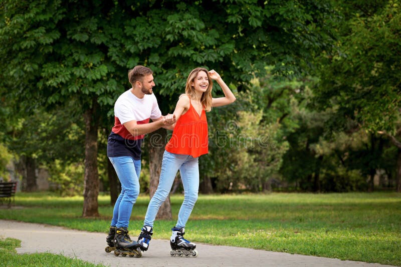 Young Happy Couple Roller Skating in Park Stock Image Image of