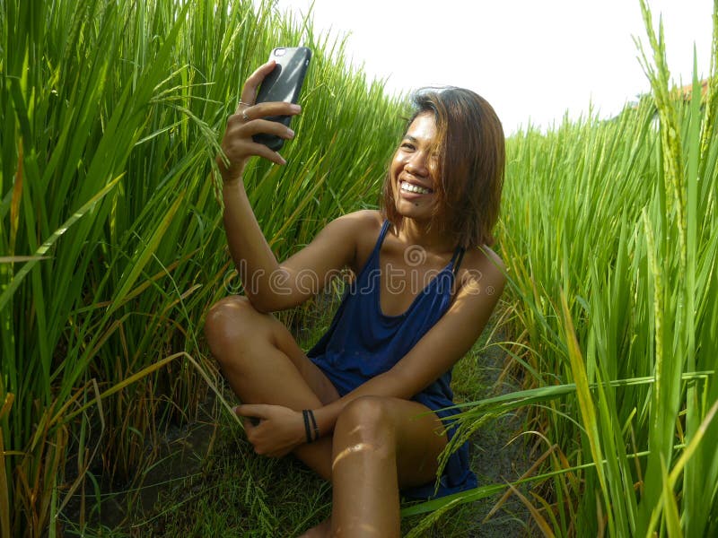 Young Happy And Exotic Islander Asian Girl From Indonesia Taking Selfie 