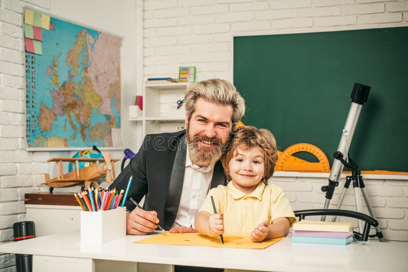 Young happy family father and son schooling math together. Education background. Elementary school tutorship. royalty free stock photography Young happy family father and son schooling math together. Education background. Elementary school tutorship. royalty free stock photography