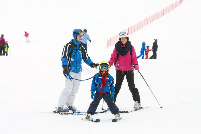 Young happy family with one child, skiing in the mountains royalty free stock photos Young happy family with one child, skiing in the mountains royalty free stock photos
