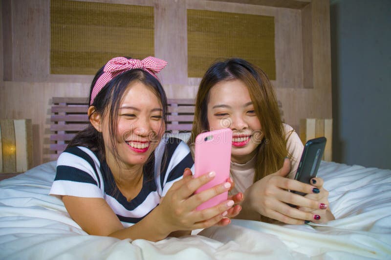https://thumbs.dreamstime.com/b/young-happy-pretty-asian-korean-girlfriends-sitting-home-bedroom-laughing-talking-having-fun-using-internet-social-two-135409206.jpg