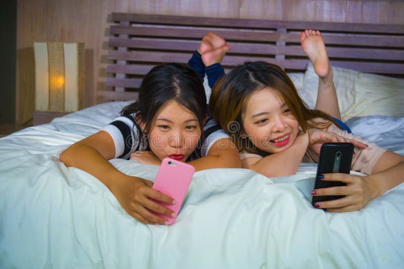 https://thumbs.dreamstime.com/b/young-happy-pretty-asian-korean-girlfriends-sitting-home-bedroom-laughing-talking-having-fun-using-internet-social-two-135409237.jpg