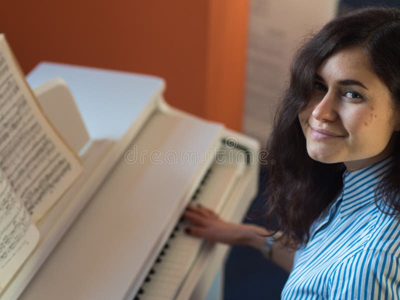 Young happy smiling caucasian woman practicing piano royalty free stock image Young happy smiling caucasian woman practicing piano royalty free stock image