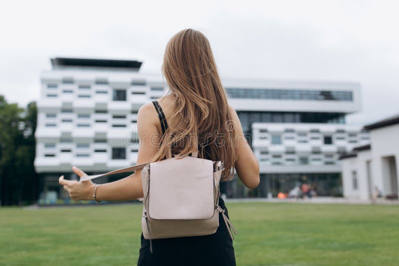 Young happy student. Students Walking Outdoors On University Campus