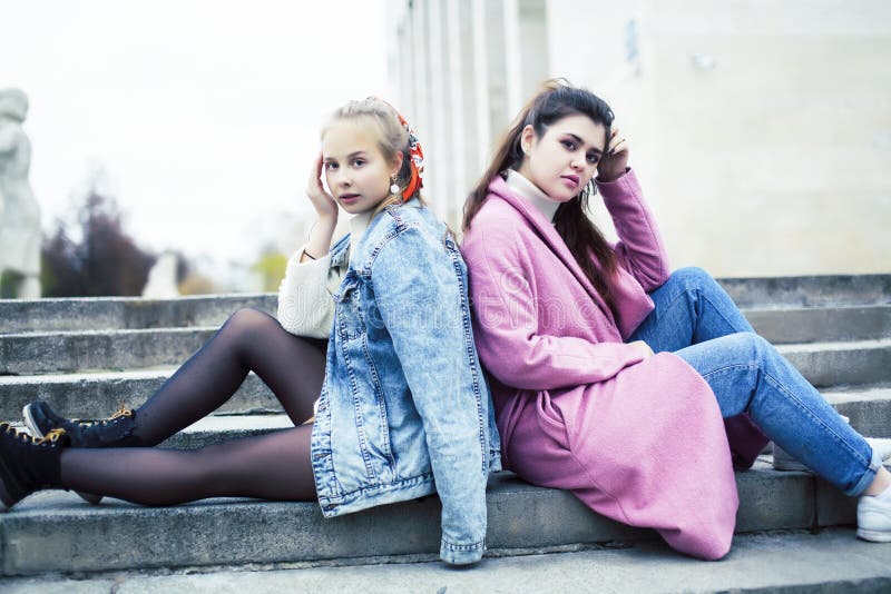 Young happy students teenagers at university building on stairs, lifestyle people concept brunette and blond girl