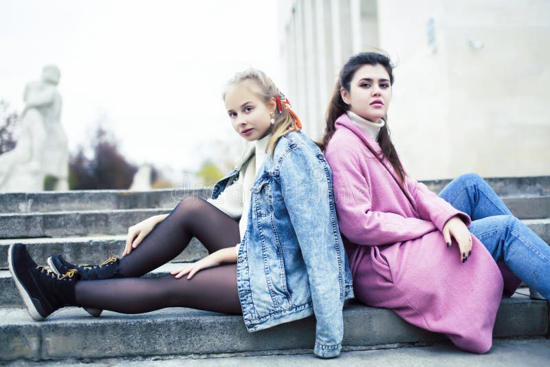 Young happy students teenagers at university building on stairs, lifestyle people concept brunette and blond girl