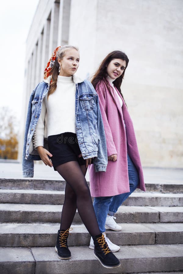 Young happy students teenagers at university building on stairs, lifestyle people concept brunette and blond girl