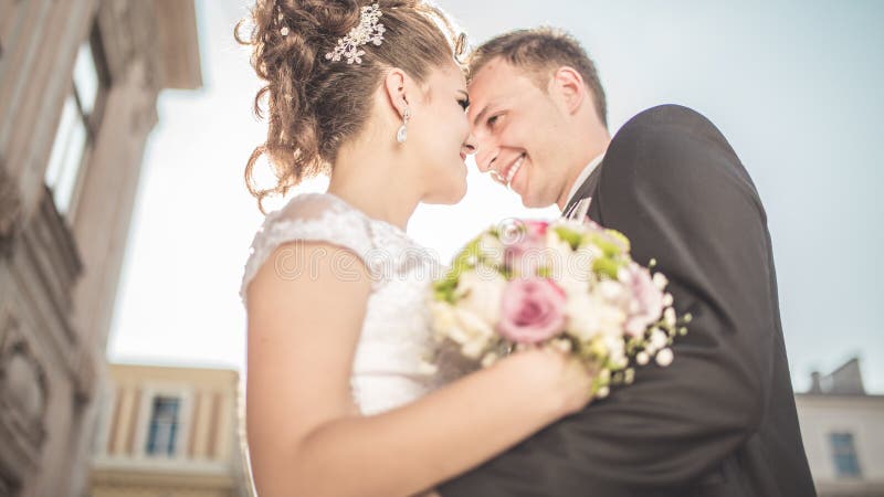 Young happy wedding couple bride meets groom on a wedding day. Happy newlyweds on terrace with gorgeous view. royalty free stock photo Young happy wedding couple bride meets groom on a wedding day. Happy newlyweds on terrace with gorgeous view. royalty free stock photo