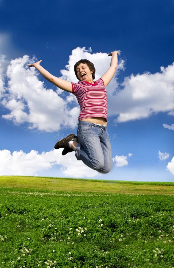 Young happy woman jumping high against blue sky