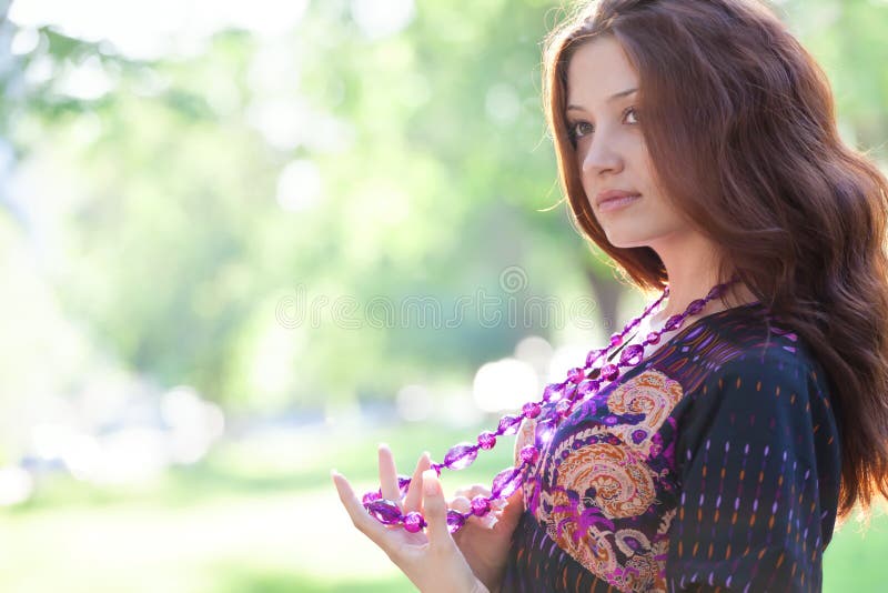 Young happy woman with purple beads