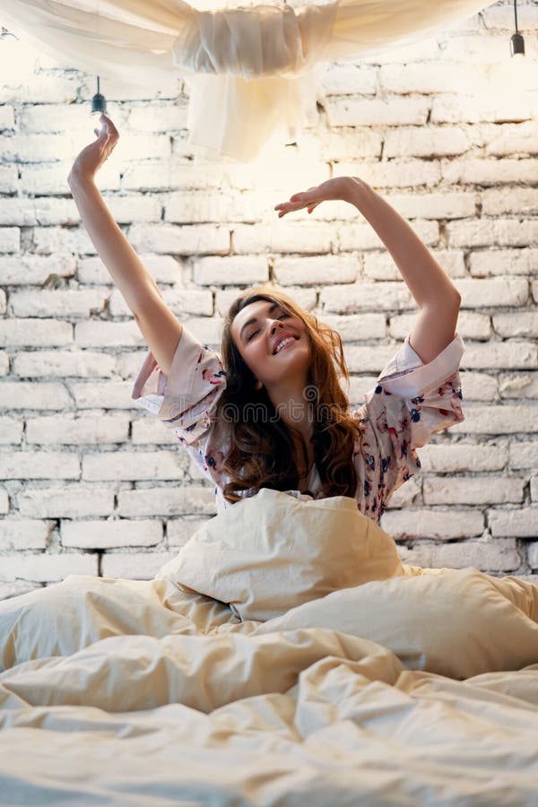 Young Woman Stretching in Bed after Wake Up in Her Modern Apartment Stock Image - Image of carefree, early: 146220937 Young Woman Stretching in Bed after Wake Up in Her Modern Apartment Stock Image - Image of carefree, early: 146220937