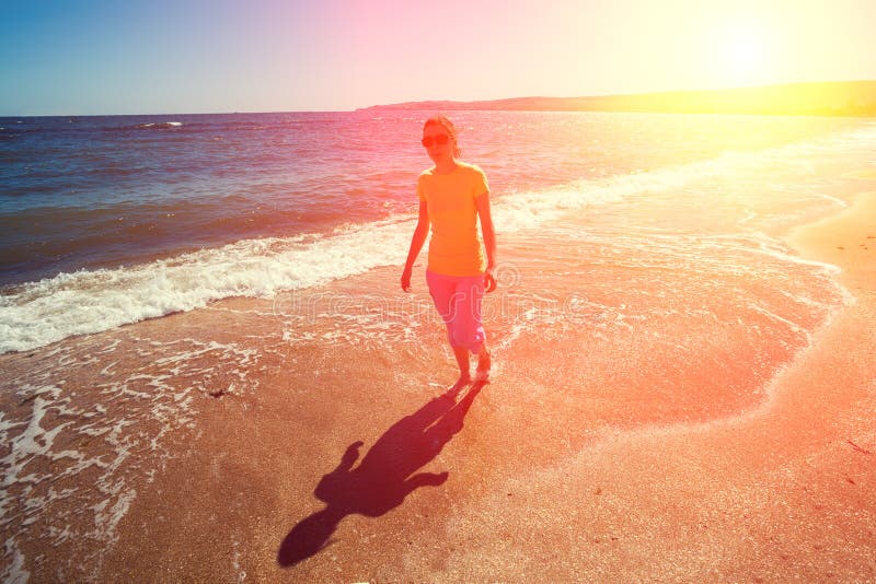 Barefoot Woman Walking On Sand Beach. Stock Image - Image 