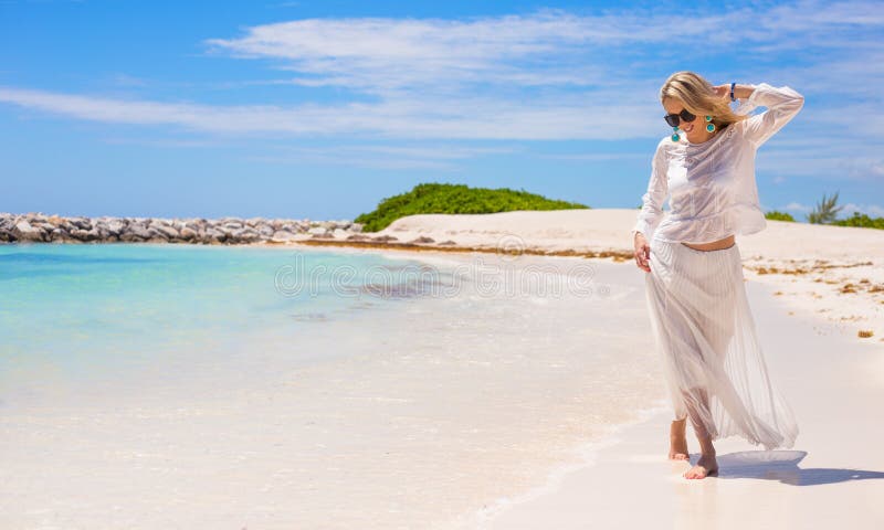 Young happy woman walking on the beach stock photography Young happy woman walking on the beach stock photography