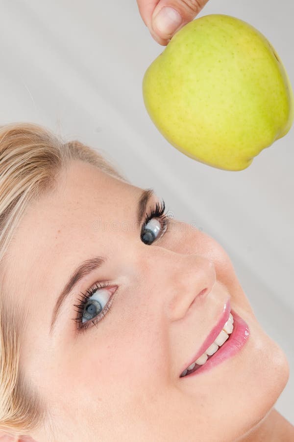 Young healthy woman with green apple