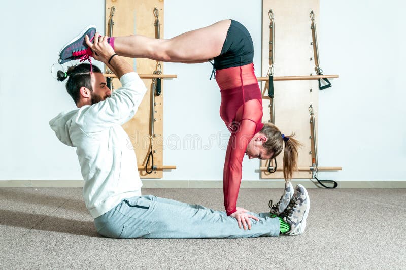 Acrobatic yoga in a gym stock image. Image of space, acrobatic - 57205871