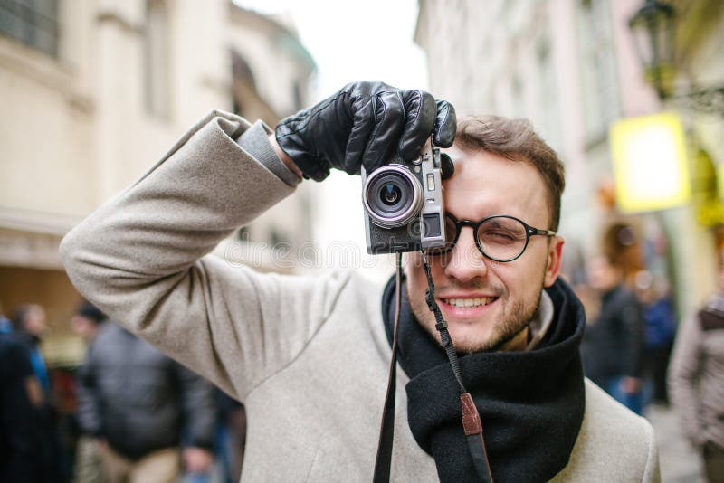 Young Hipster Taking Pictures Outdoor Using Old Film Camera Stock Photo