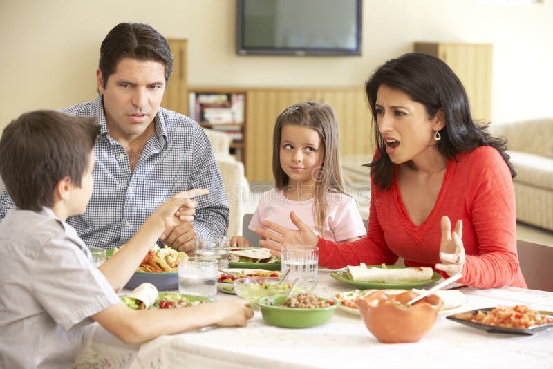 Young Hispanic Family Enjoying Meal At Home royalty free stock photo Young Hispanic Family Enjoying Meal At Home royalty free stock photo