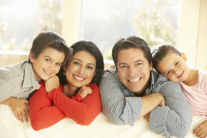 Young Hispanic Family Relaxing On Sofa At Home stock image Young Hispanic Family Relaxing On Sofa At Home stock image