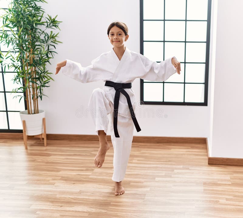 Young Hispanic Girl Doing Martial Arts at Training Studio Stock Photo
