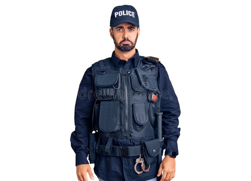 Young hispanic man wearing police uniform depressed and worry for distress, crying angry and afraid. Sad expression royalty free stock photography Young hispanic man wearing police uniform depressed and worry for distress, crying angry and afraid. Sad expression royalty free stock photography