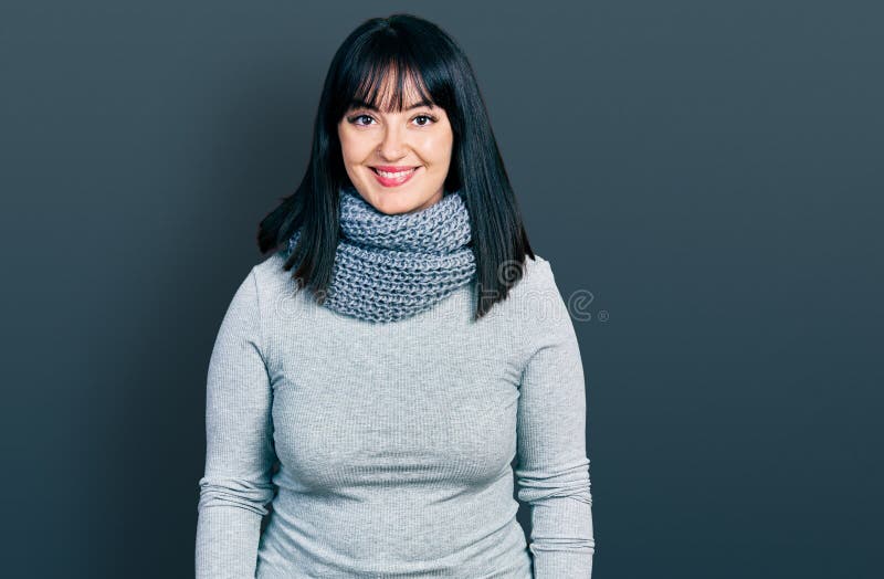 Young hispanic plus size woman wearing winter scarf with a happy and cool smile on face