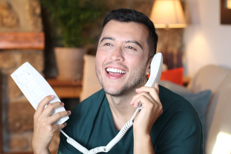 Young hispanic using retro style landline phone royalty free stock image