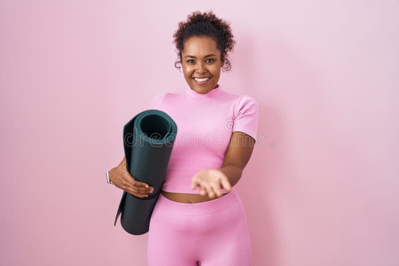Free Photo  African woman doing yoga in studio. pink background.