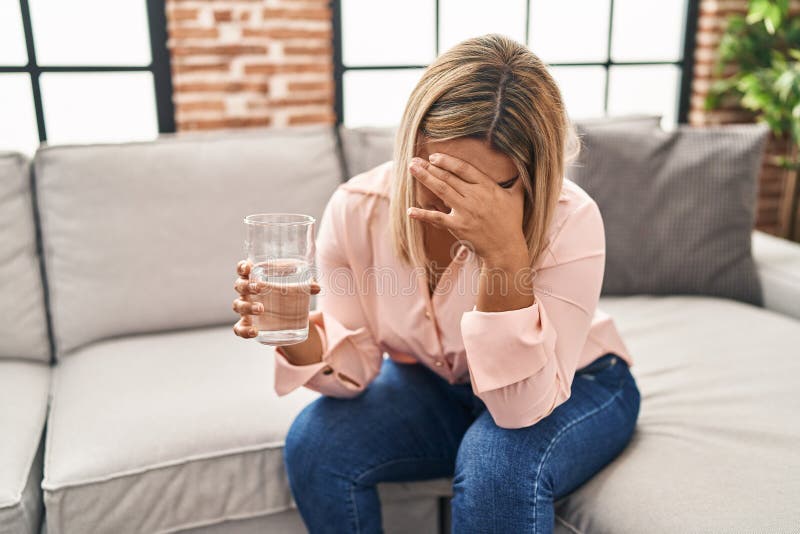 Young Hispanic Woman Suffering for Headache Drinking Water at Home Stock Photo Image of sofa