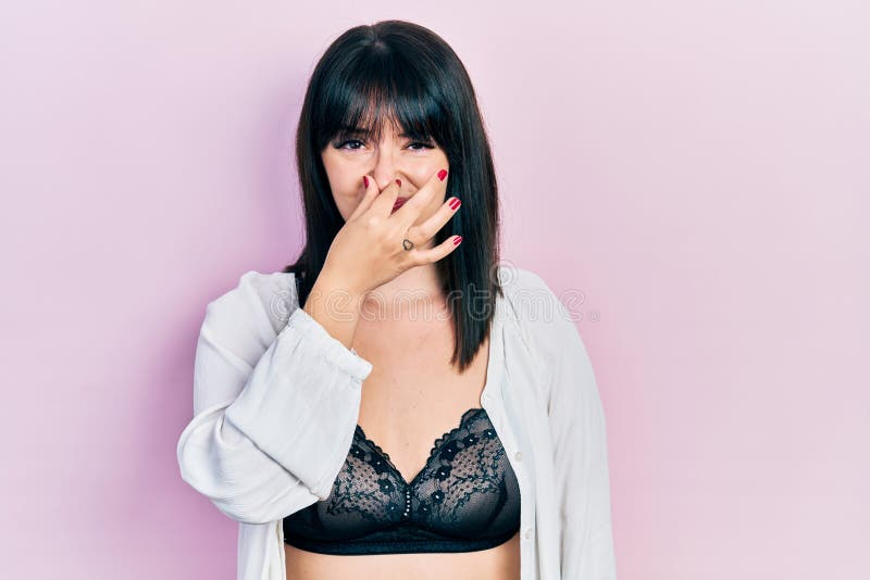 Young Hispanic Woman Wearing Lingerie Smelling Something Stinky and  Disgusting, Intolerable Smell, Holding Breath with Fingers on Stock Photo -  Image of expression, female: 213171704