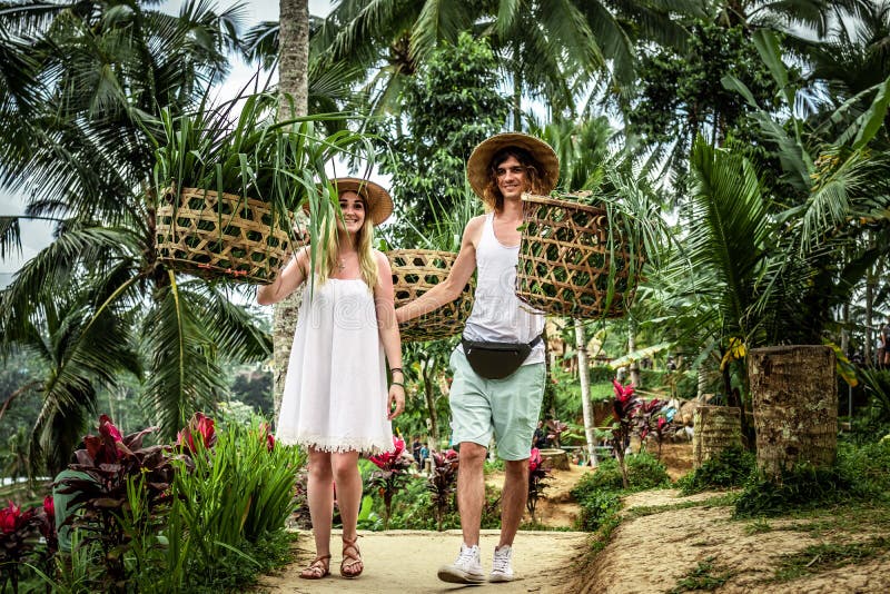 Young honeymoon couple on rice fields of Bali island. Travel vacation on Bali concept.