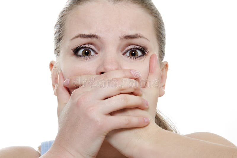 Young horrified woman closing her mouth with hands