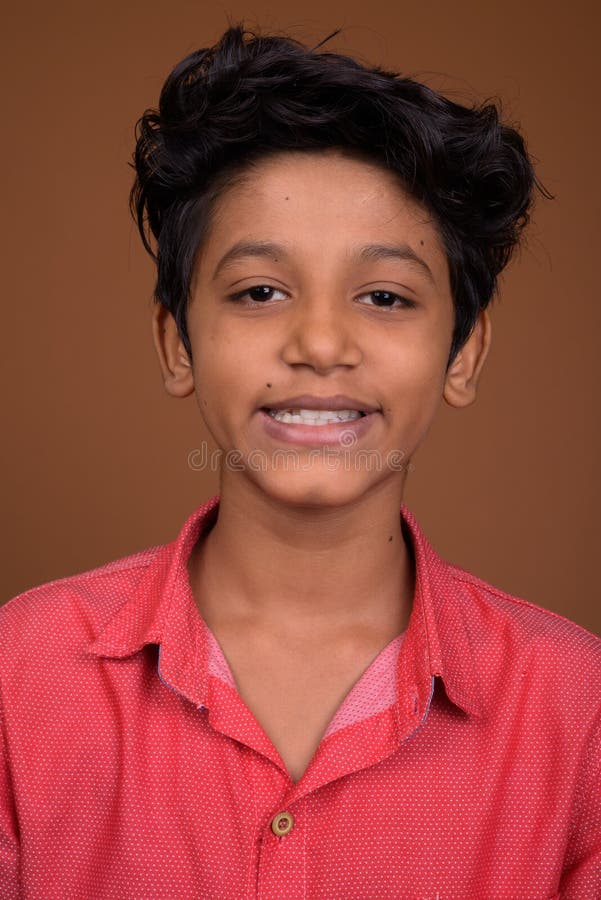 Young Indian Boy Wearing Smart Casual Clothing Against Brown Bac Stock  Photo - Image of studio, close: 124753970