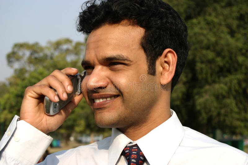 Young Indian business man on mobile royalty free stock photography Young Indian business man on mobile royalty free stock photography