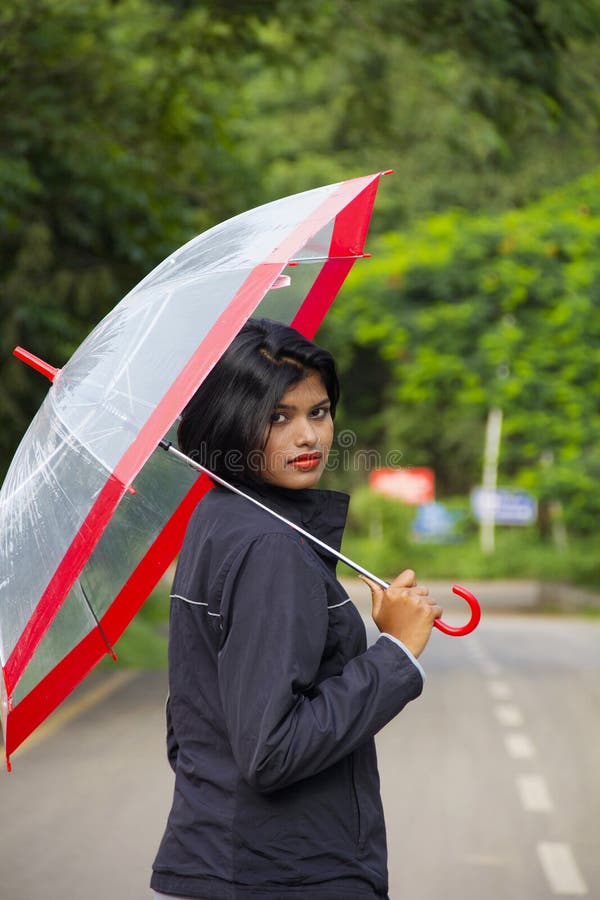 Young Indian Girl with Short Hair Holding a Transparent Umbrella and  Looking Back, Pune Stock Image - Image of cute, glamour: 145070749