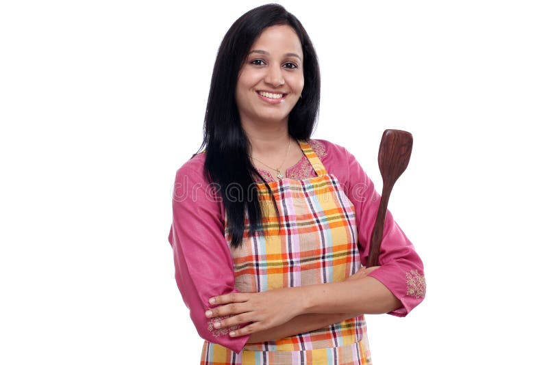 Young Indian woman holding kitchen utensil against white stock image Young Indian woman holding kitchen utensil against white stock image