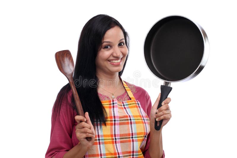Young Indian woman holding kitchen utensil stock photos Young Indian woman holding kitchen utensil stock photos